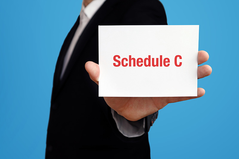 Man holding Schedule C card up