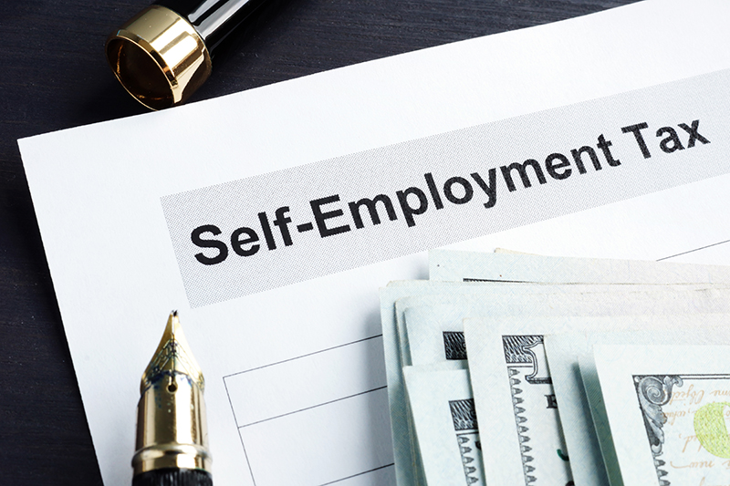 Self-Employment Tax, Pen, and Stack of Money