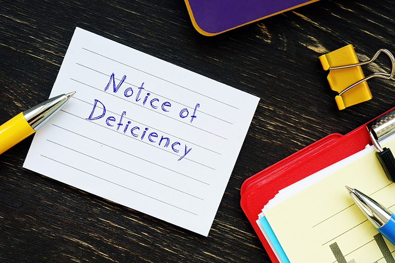 Notice of Deficiency written on a piece of paper